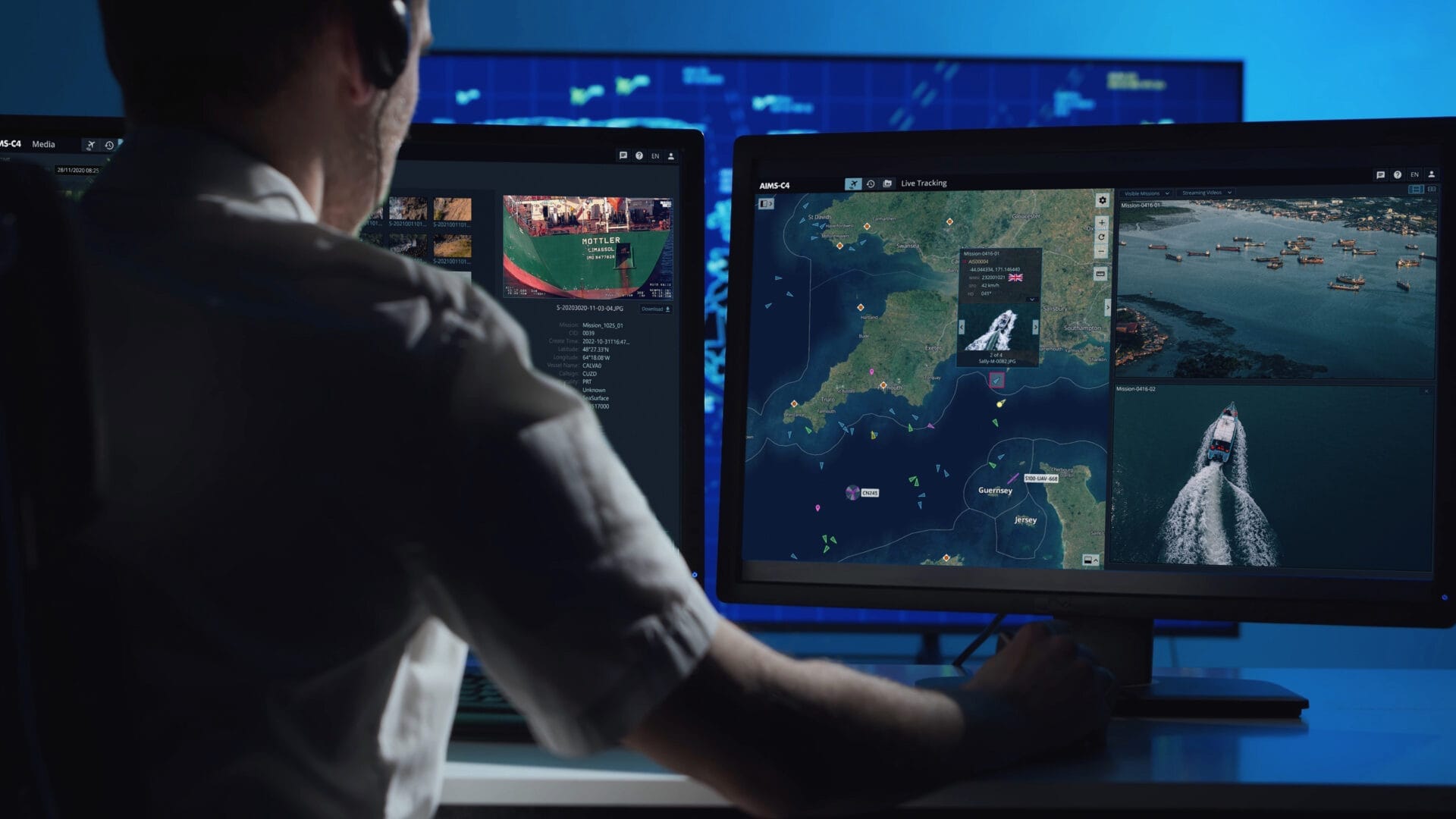 Photograph of an operator behind a screen displaying the mission software interface
