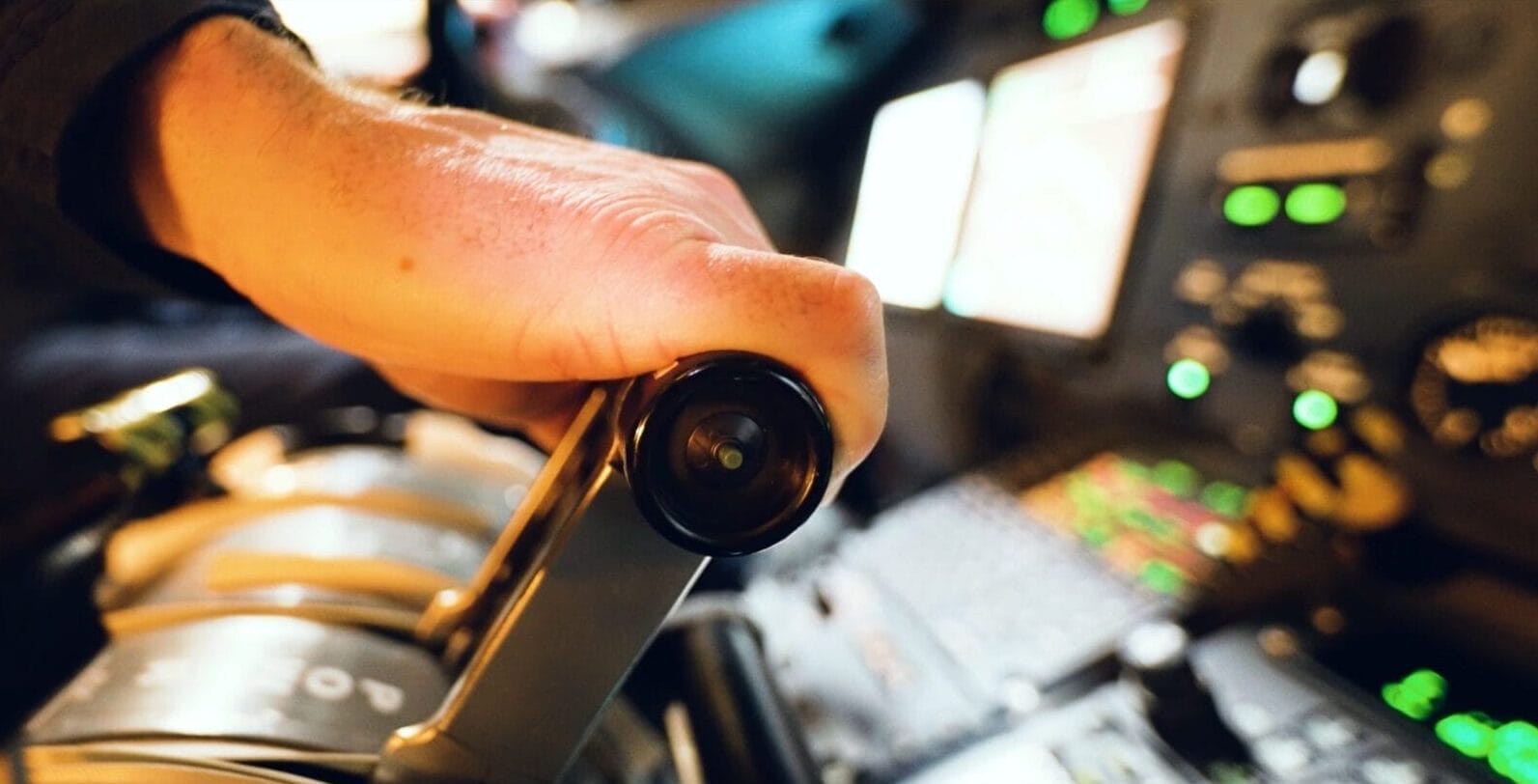 Close-up of pilots hand moving throttle forward