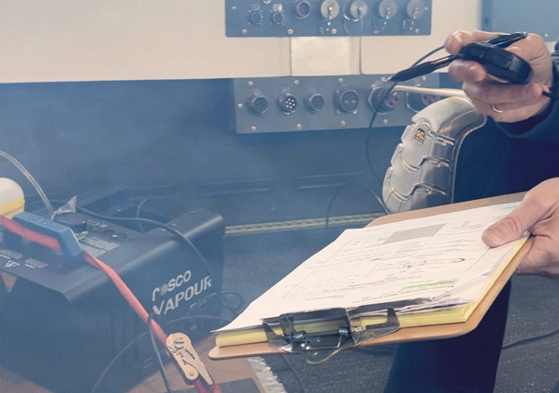 Photograph of a PAL operator with a checklist in a smoke-filled space