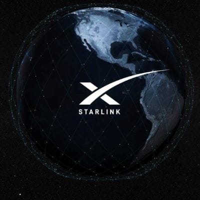 A view of Earth from space at night, highlighting the Americas, with the Starlink logo and network grid lines superimposed over the globe on a dark background—showcasing Starlink as a Force Multiplier for global connectivity.